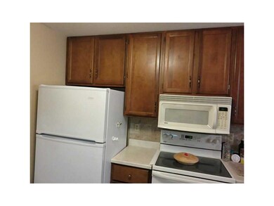 Kitchen. White refrigerator, buiilt-in microwave a