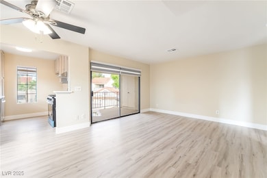 Spare room featuring light wood-type flooring and ceiling fan