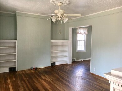 The formal living room has the original hard wood 