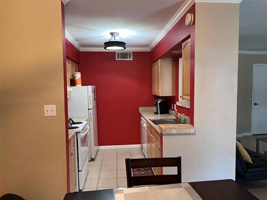Kitchen with white appliances, sink, crown molding