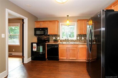 Warm maple cabinets and custom backsplash create a