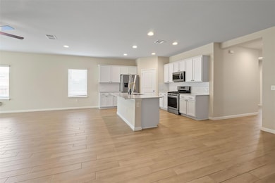 Kitchen with open floor plan, stainless steel app