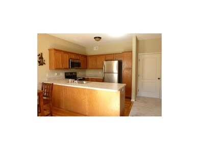 Kitchen features stainless steel appliances, wood 