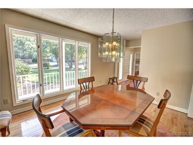 Formal dining room with large window and hardwood 