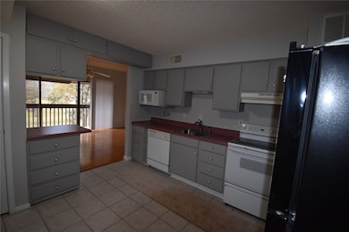 Cozy kitchen with gray cabinets, featuring a stove