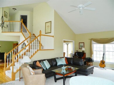 An elegant turned staircase overlooks the foyer an