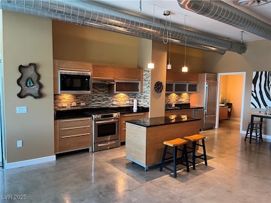 Kitchen featuring built in appliances, a high ceil