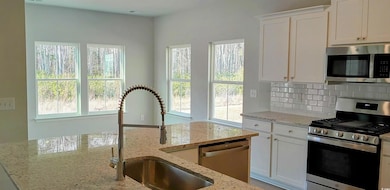 Kitchen with appliances with stainless steel finis