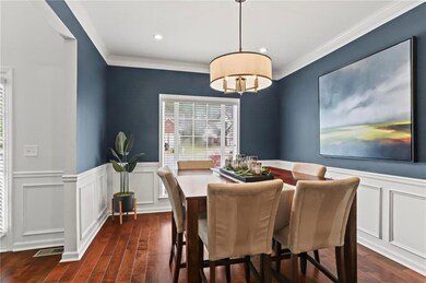 Dining room with a wainscoted wall, crown molding,