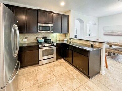 Kitchen with stainless steel appliances, decorati