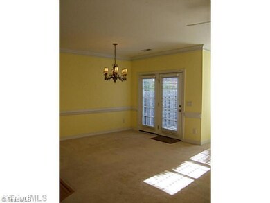 Dining Room. Spacious dining room with beautiful chandelier and French doors to patio.