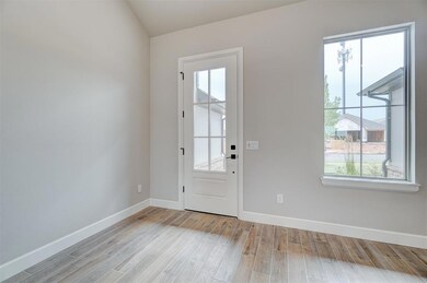 Doorway to outside with light hardwood / wood-styl
