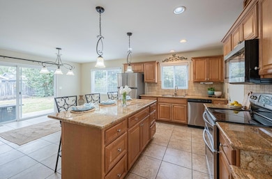 Open & spacious granite kitchen with tiled floors that opens to large dining area.