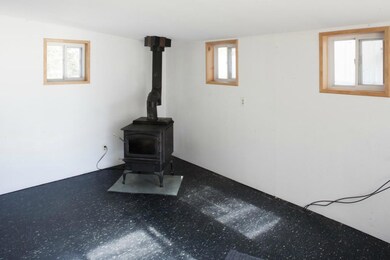 Living room includes Regency wood stove