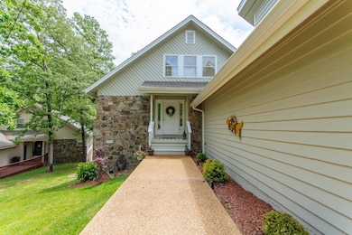 Property entrance featuring a yard and stone sidin