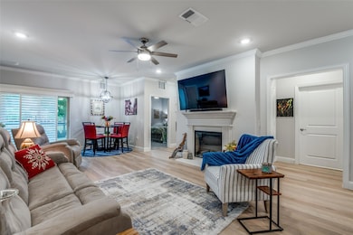 Living room featuring ceiling fan, light hardwood 