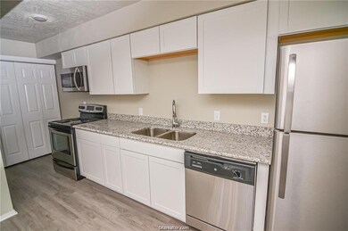 Kitchen featuring white cabinets, appliances with stainless steel finishes, and sink