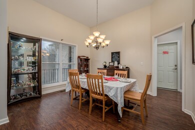 Formal dining room with elevated ceiling and views of the trees!