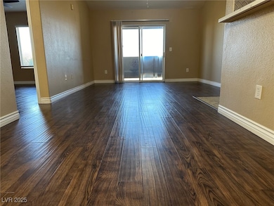 Empty room featuring dark wood finished floors, ba