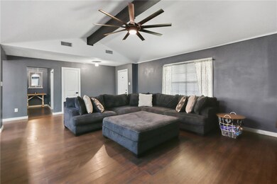 Living room with ceiling fan and wood finished flo