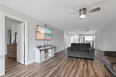 Living room featuring ceiling fan and hardwood / w