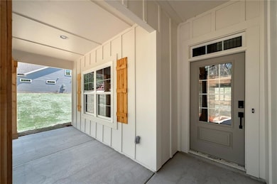 Entrance to property with board and batten siding 