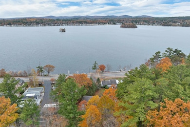 Drone view to see how close Lake Winnipesaukee is for you to walk across the street to the day dock.