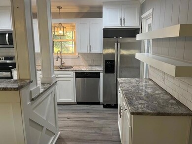 Kitchen featuring hanging light fixtures, stainles