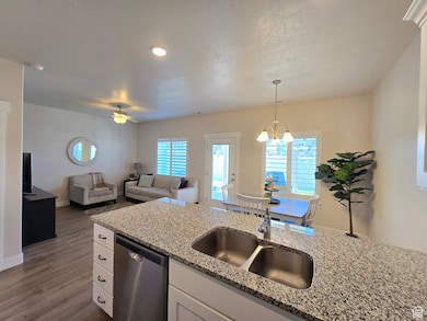 Kitchen with white cabinetry, stainless steel dishwasher, healthy amount of natural light, a ceiling fan, and recessed lighting