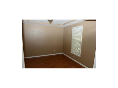 Dining room with laminate floor and beveled ceilin