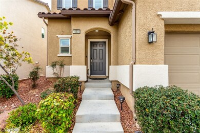 Doorway to property with a garage and stucco sidin