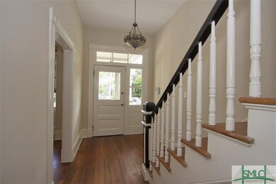 This gracious foyer opens to a gorgeous stairwell 