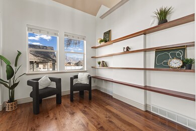 Living area featuring dark wood-type flooring and baseboards