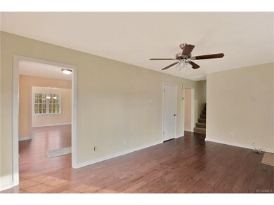 Living room with view into kitchen and dining area