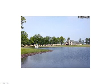 View of home from across the 2 acre stocked pond.