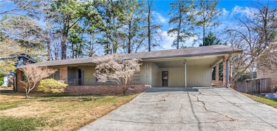 Ranch-style house with brick siding, fence, aphalt