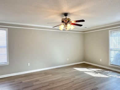 Spare room with ornamental molding, baseboards, a 