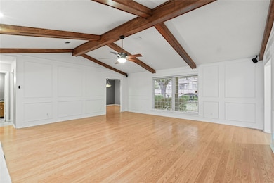 Unfurnished living room with lofted ceiling with b