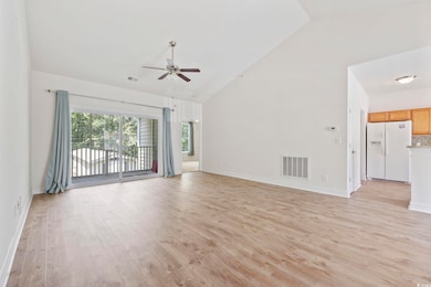 Unfurnished living room featuring high vaulted cei