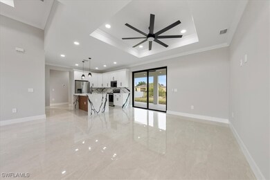 Unfurnished living room with a tray ceiling, a cei