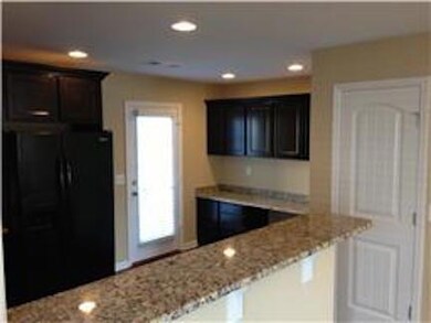 A view to kitchen from dining room and towards the work station.