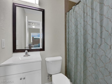 Bathroom with vanity, walk in shower, and toilet