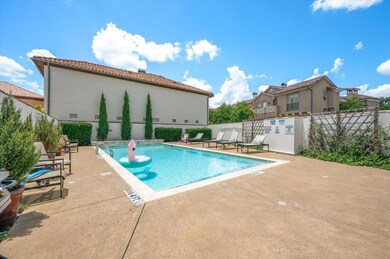 Community pool with a patio and fence