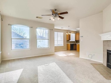 Unfurnished living room with ceiling fan, a tile 
