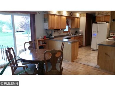 Open dining to kitchen and patio doors to large ag