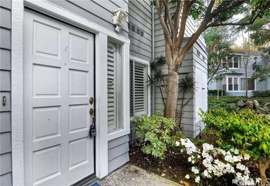 Lush entry way leading to front door of unit