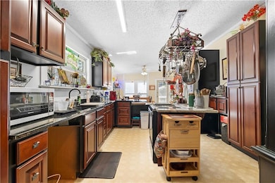 Kitchen featuring a sink, a ceiling fan, plenty of