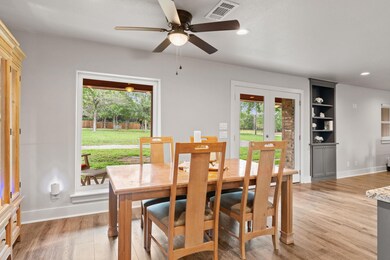 Dining area with baseboards, a ceiling fan, light