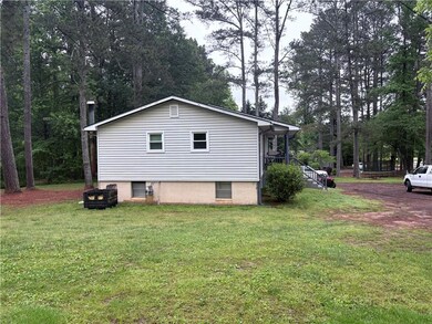 View of property exterior with a yard and view of 