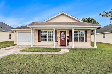 View of front of house with a shingled roof, a porch, a front yard, and driveway